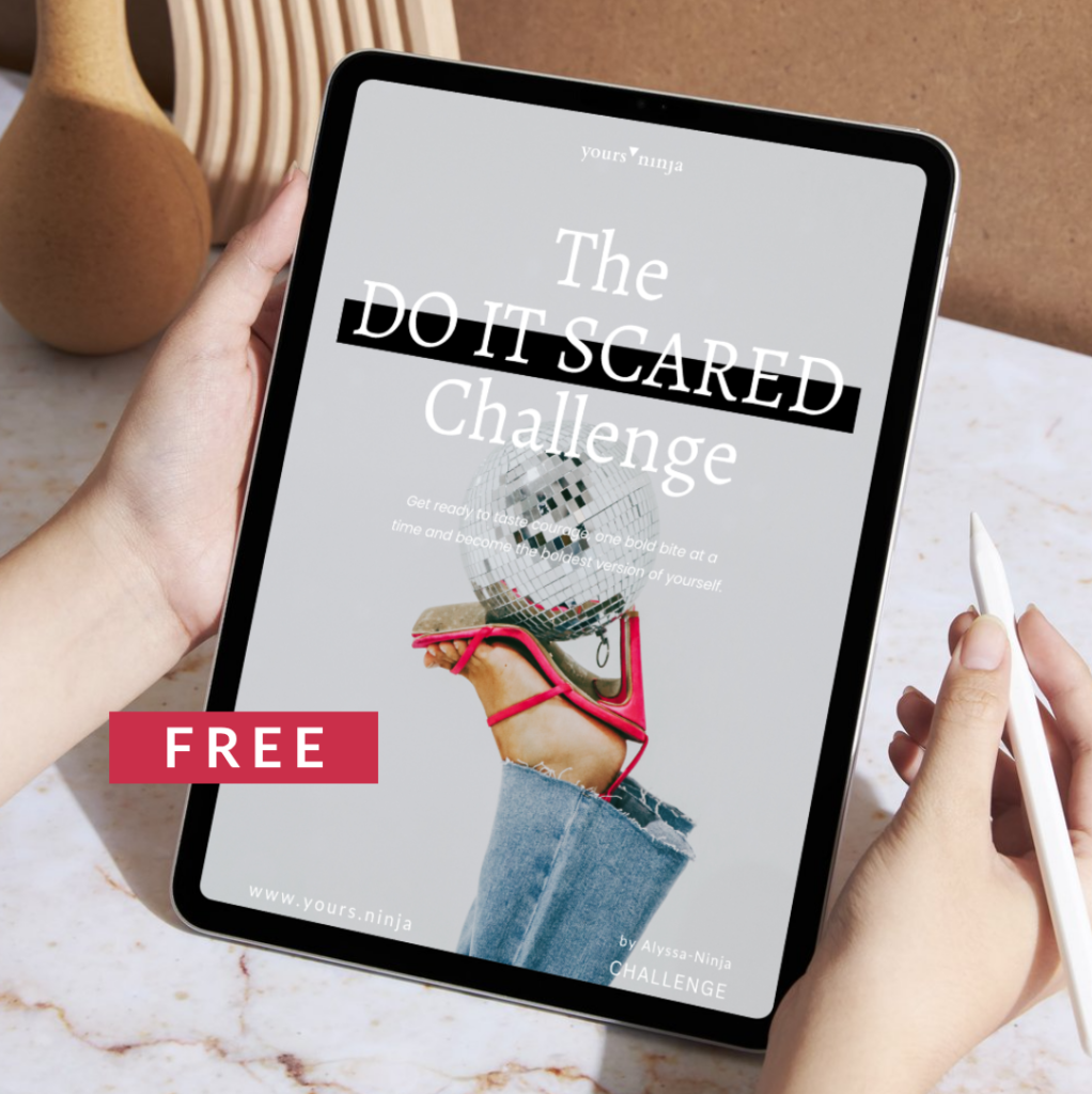 A woman holding a tablet with the free Do It Scared Challenge open